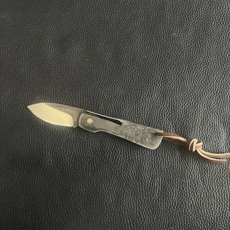 Couteau pliant Pierre Marfisi sur fond de cuir